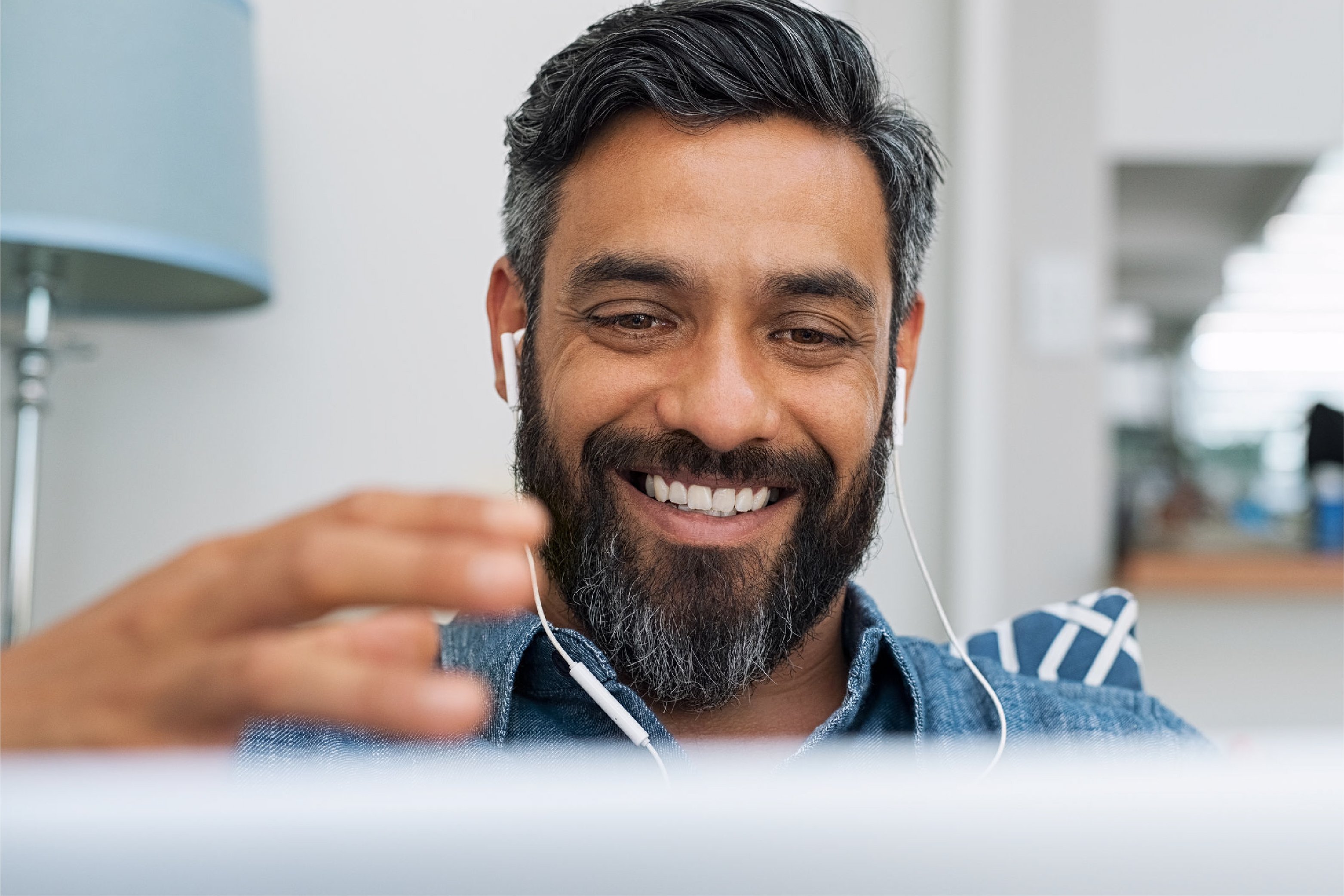 Man with headphones looking at computer screen