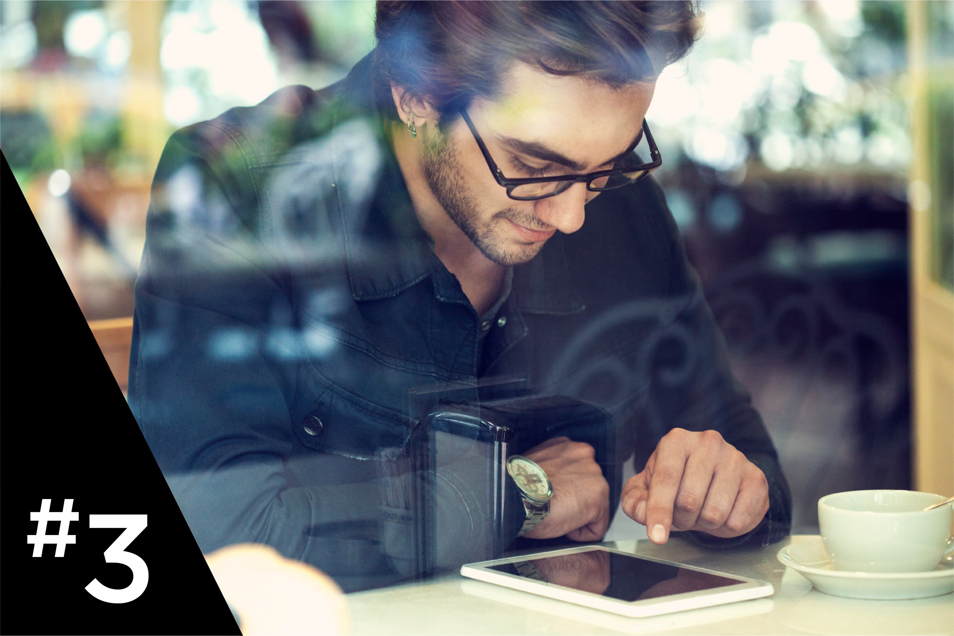 Man working on tablet with cup of coffee